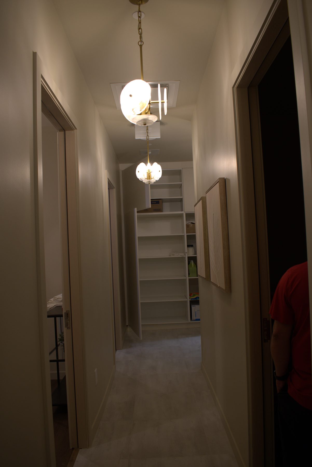 Hallway with modern pendant lights and empty shelving unit — Leela Spa (Bankers Hall)