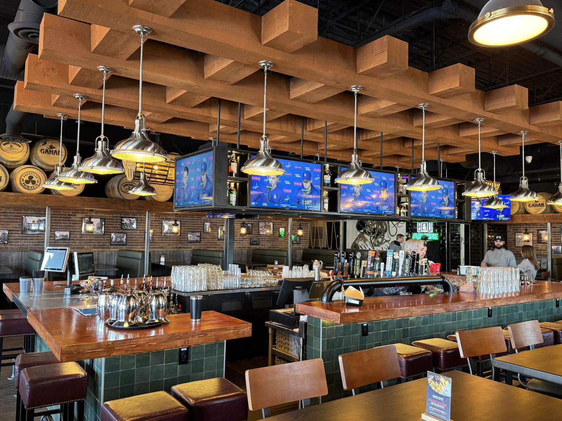 Restaurant bar area with wooden beams, pendant lights, and televisions — Blowers and Grafton (Medicine Hat)