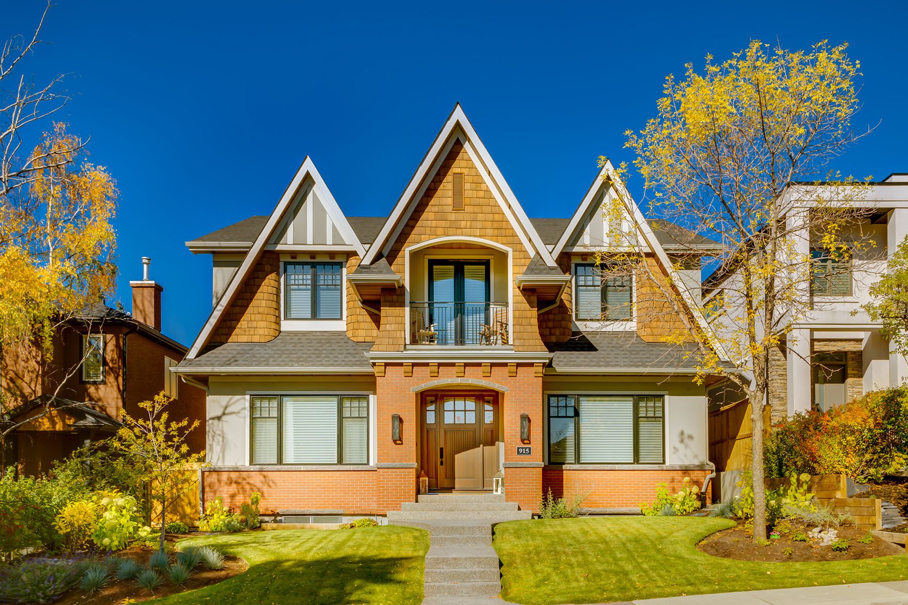 Newly constructed house with wood siding, brick facade, and balcony — Cleret Velour by Onsite Contracting Services