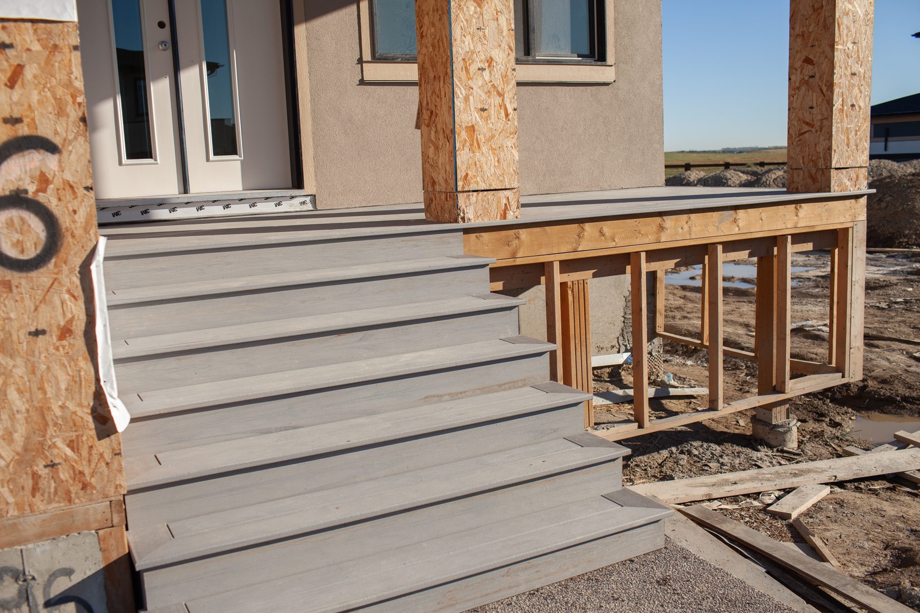 New grey composite stairs and deck framing under construction — 96 Fieldstone Close