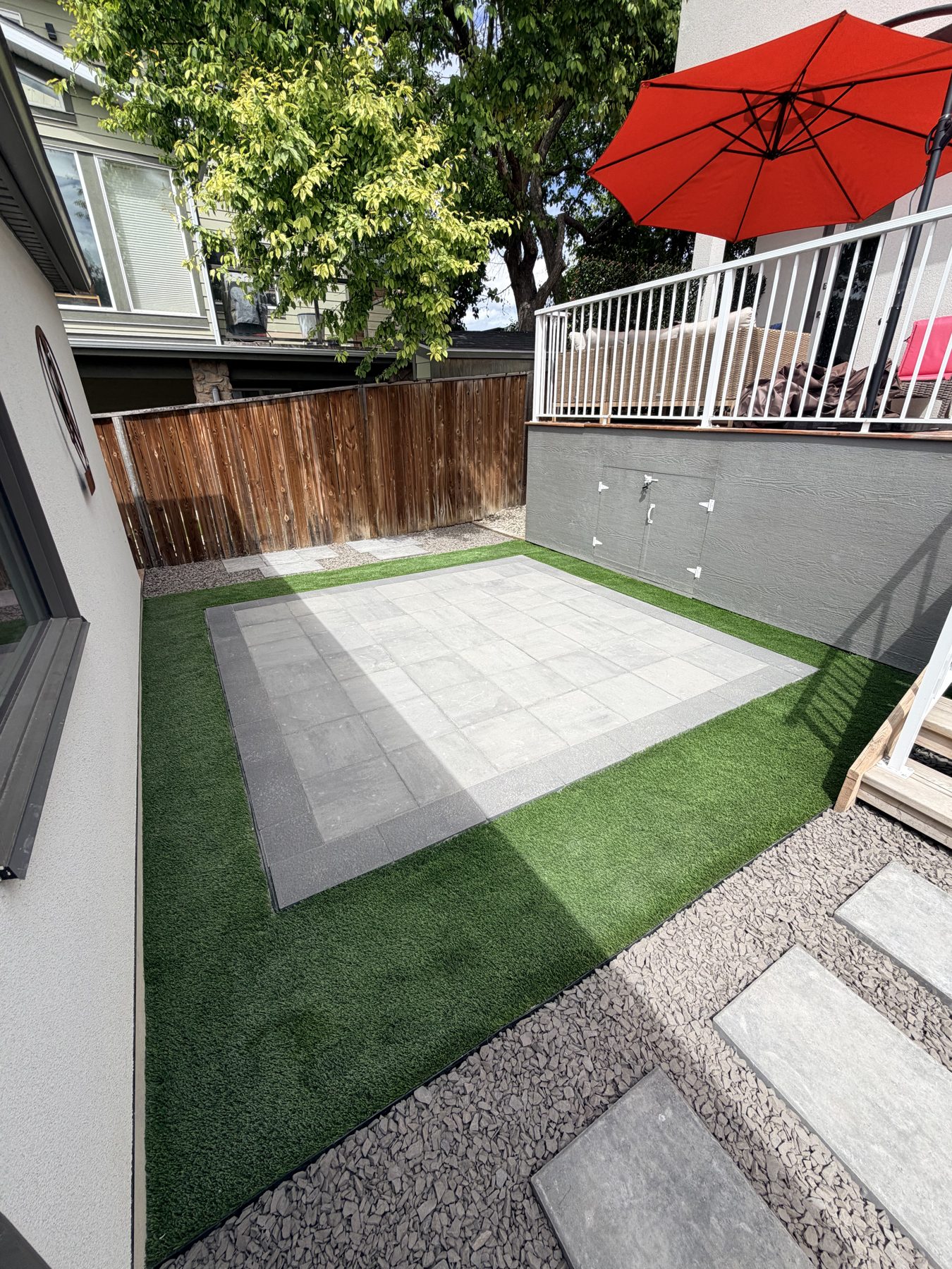 Backyard patio with artificial turf, stone pavers, and gravel landscaping — 3505 41 Street SW, Calgary