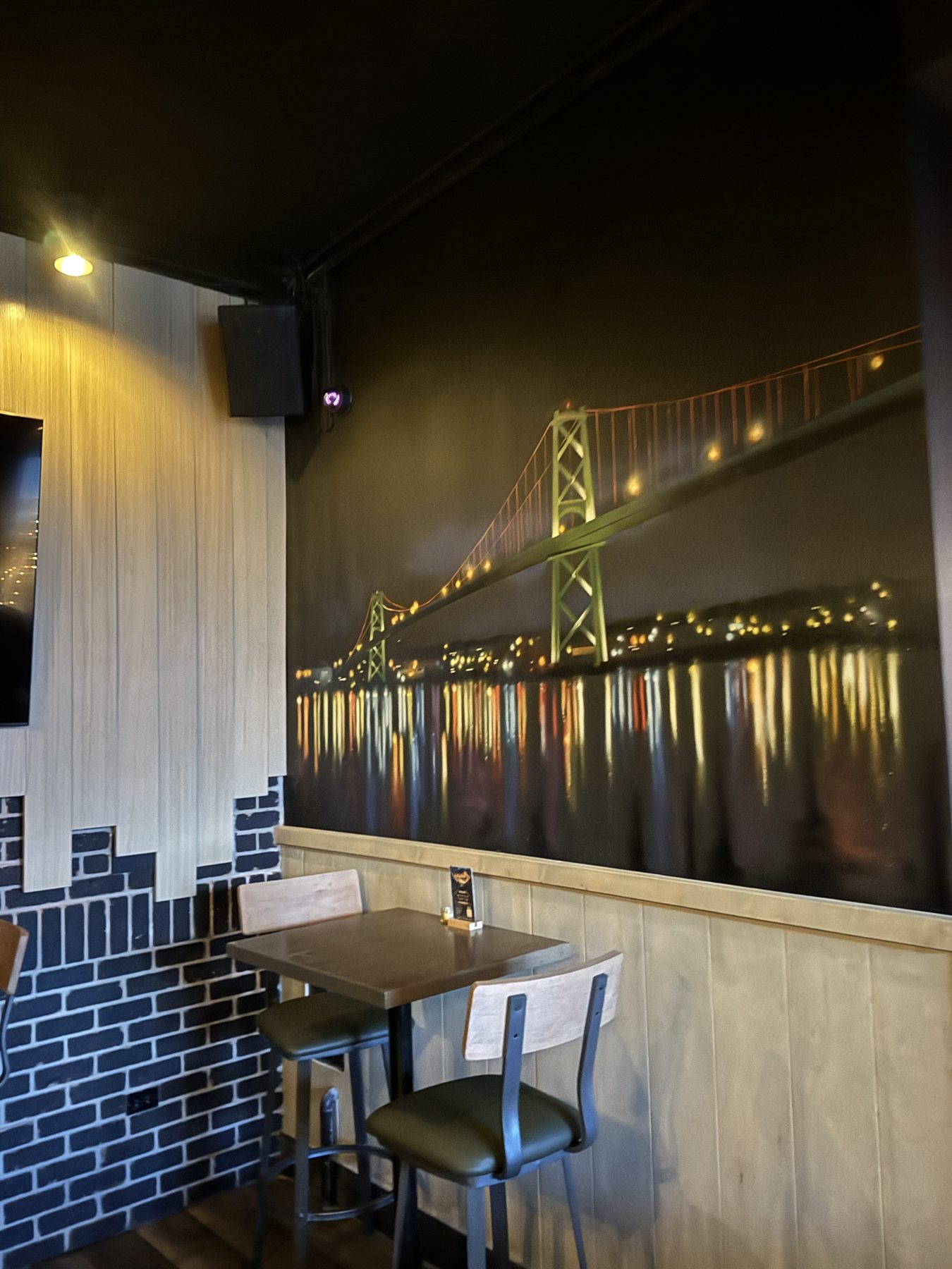 Bar seating area with mural of bridge and city lights — Blowers and Grafton (Mission)