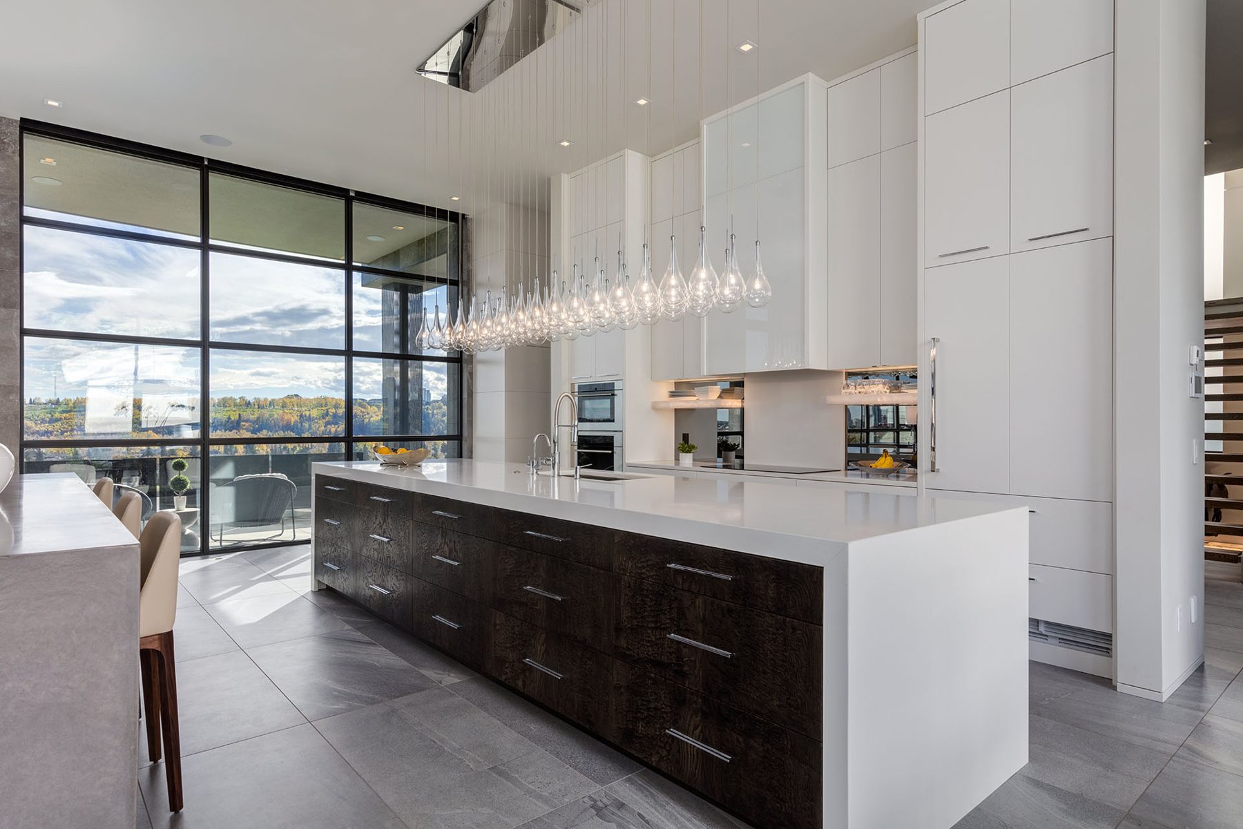 Modern kitchen island with dark wood drawers and white quartz countertop — Infinity