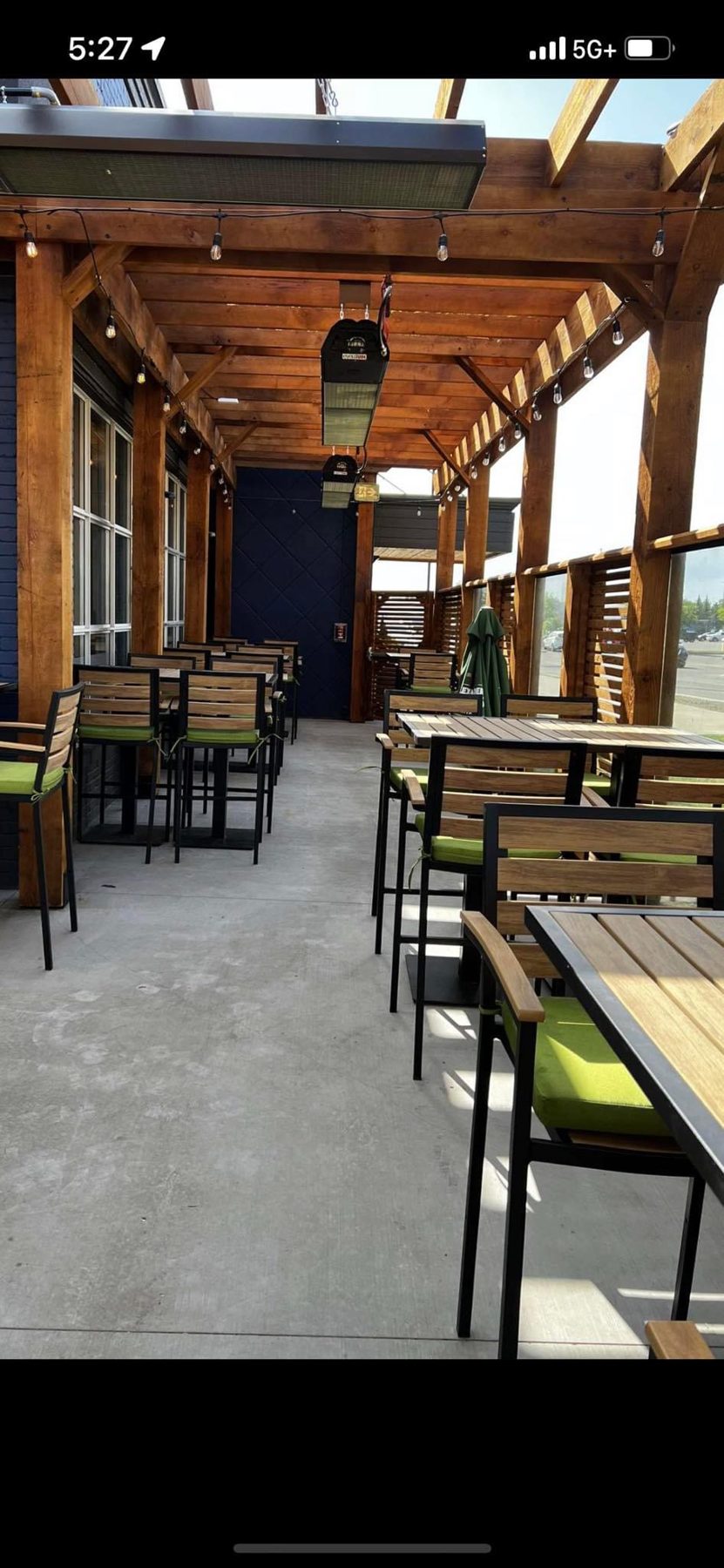 Outdoor patio with wooden beams, tables, chairs, and heaters — Blowers and Grafton (Lethbridge)