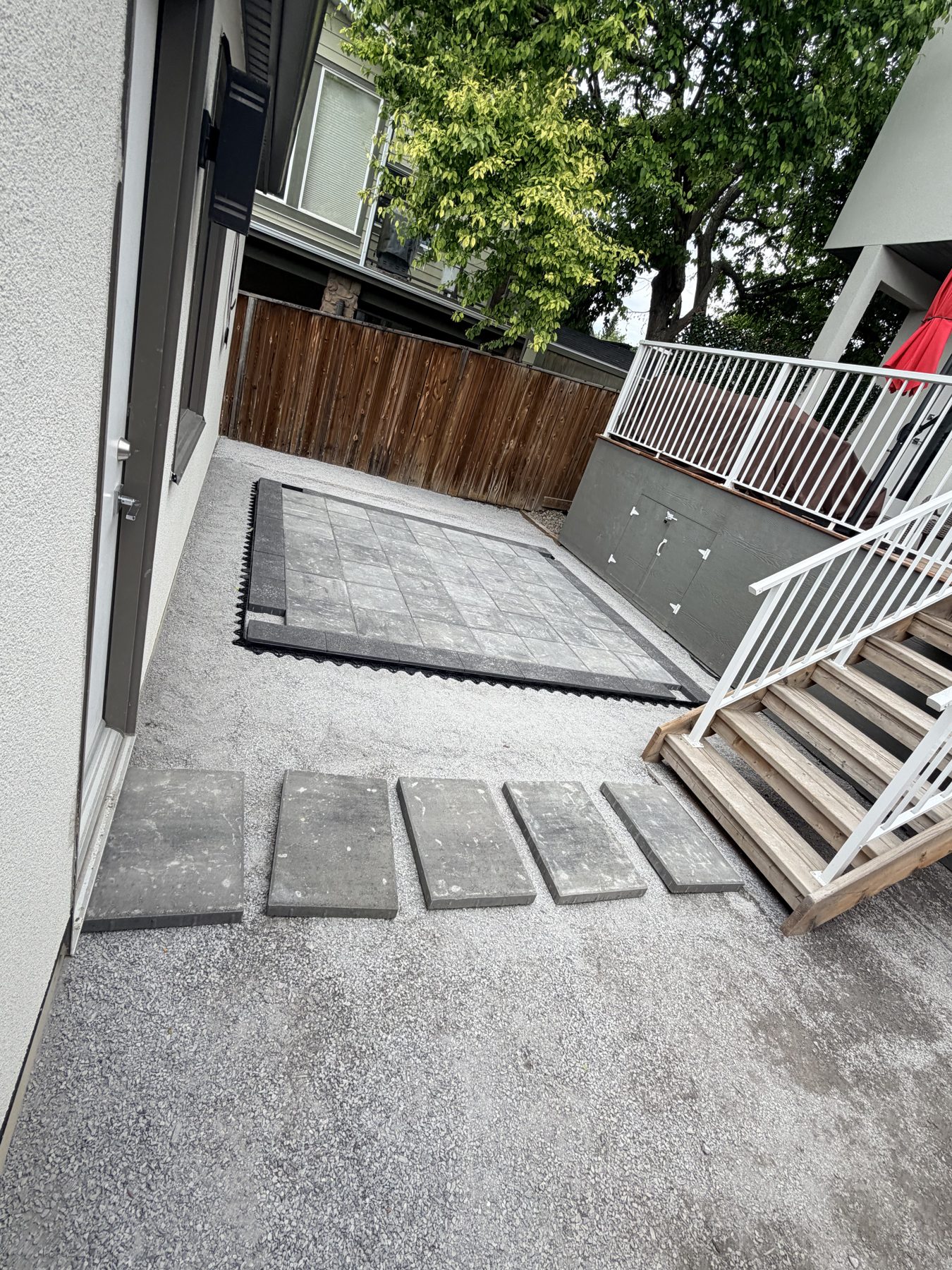 Paving stones laid on gravel, with wooden stairs and decking — 3505 41 Street SW, Calgary
