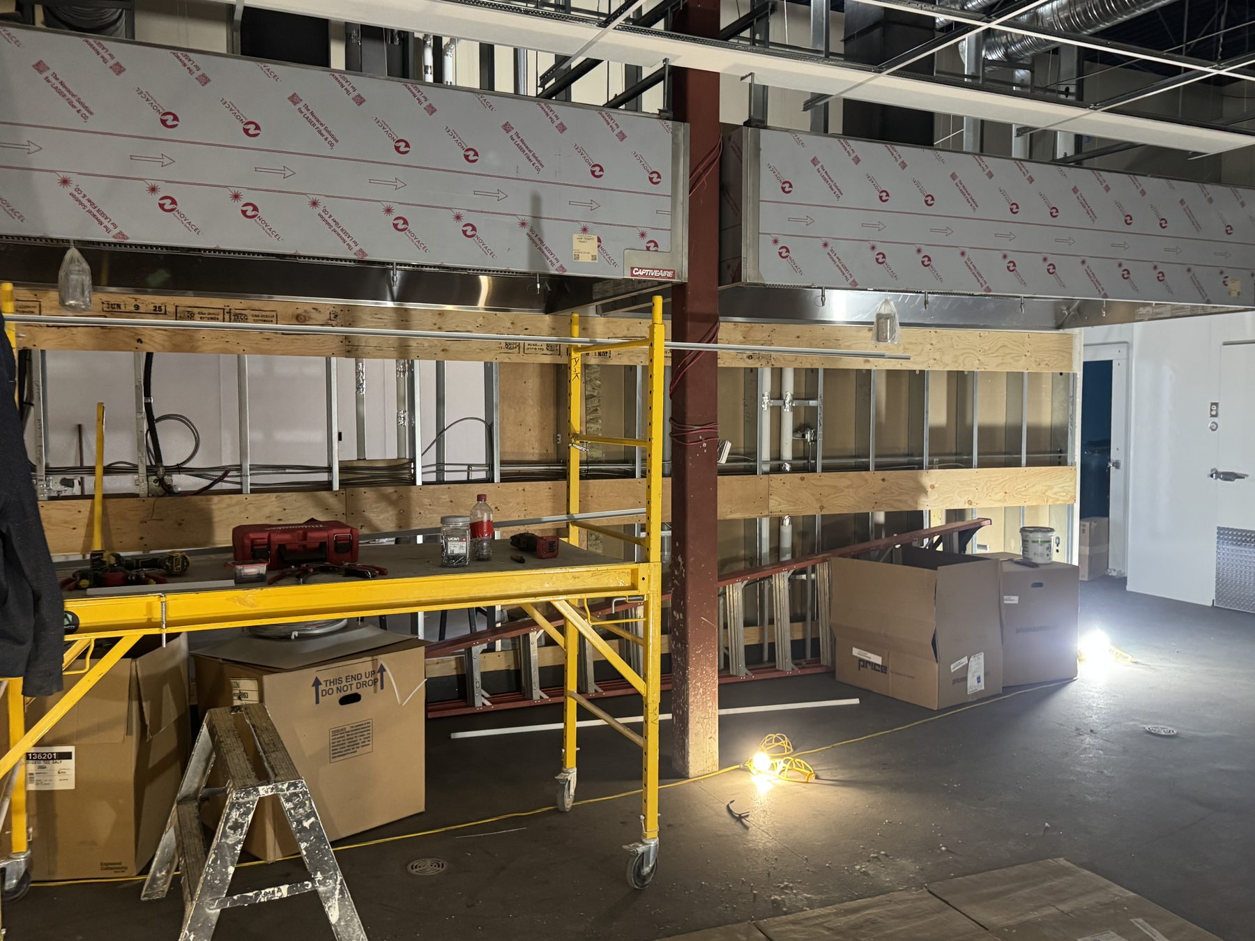 Kitchen hood installation in progress with scaffolding and materials — Blowers and Grafton (Red Deer)