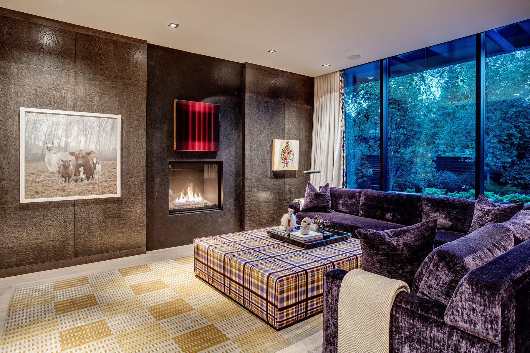 Living room with modern fireplace, plush sectional, and large window — Modern Family