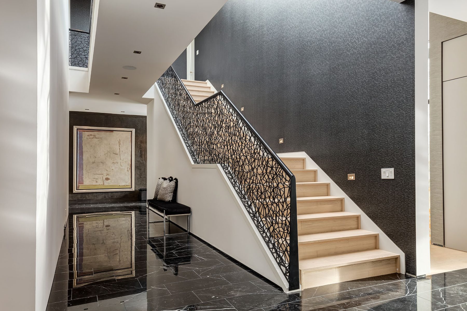 Modern staircase with black metal railing and wood treads, dark textured wallpaper — Modern Family