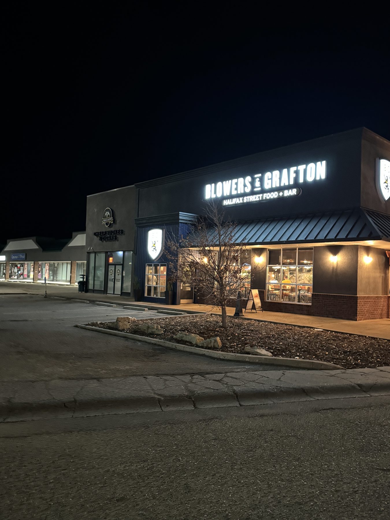 Exterior view of a restaurant at night with illuminated signage and storefront — Blowers and Grafton (Medicine Hat)