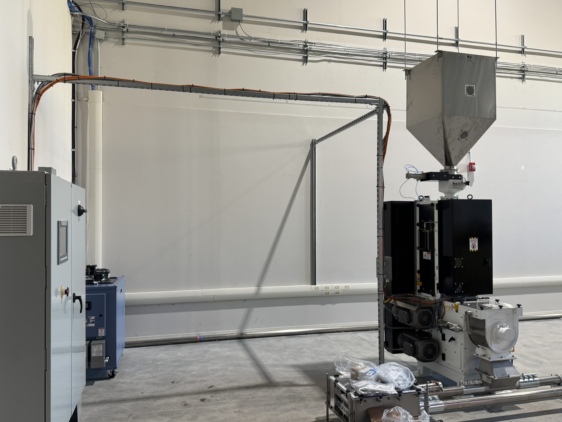 Industrial equipment installation with electrical conduits and machinery — Eight Ounce Coffee