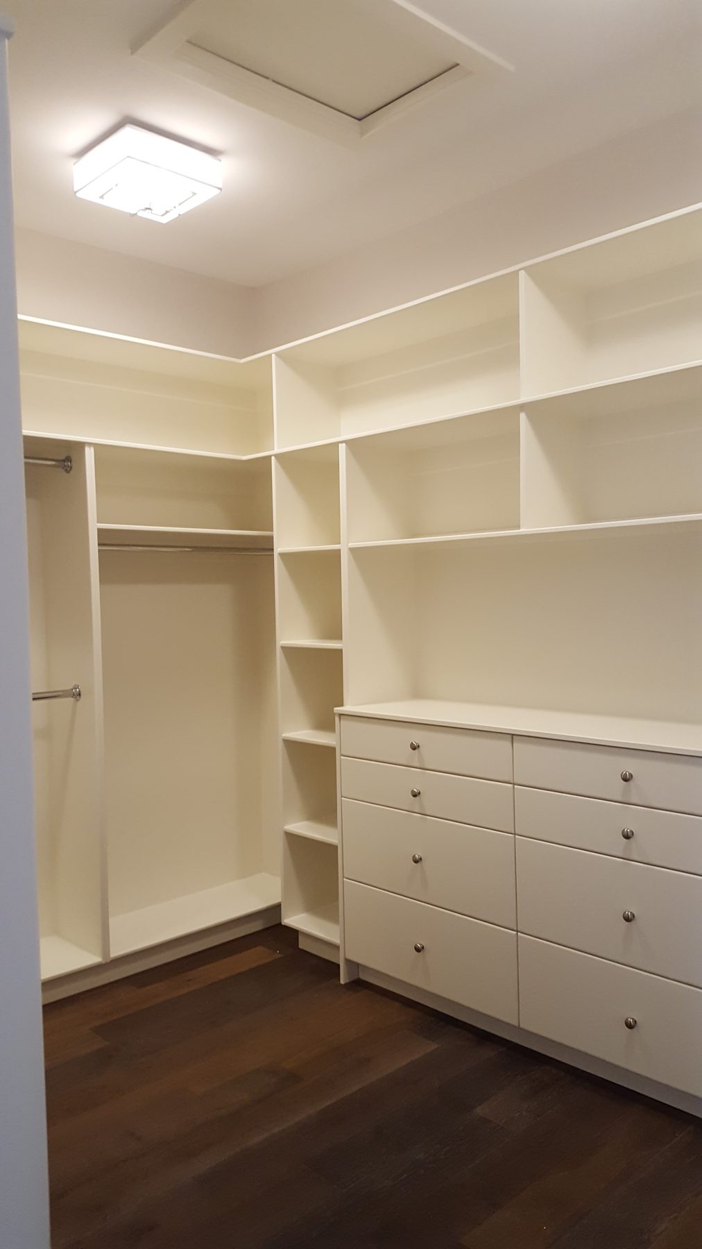 Custom closet shelves, drawers, and dark wood floor installed — Briar Hill