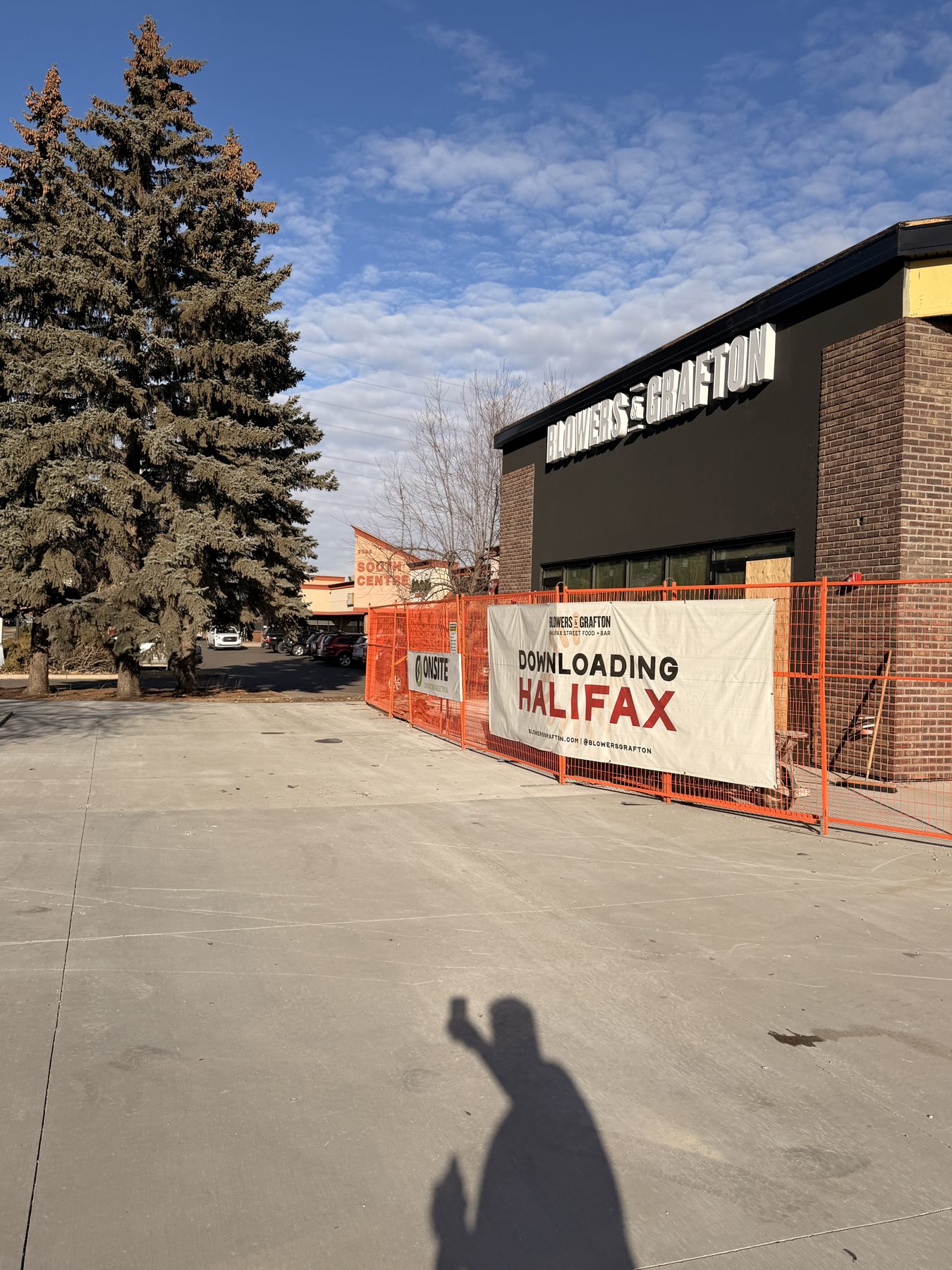 Construction site with scaffolding, banner, and brick building signage — Blowers and Grafton (Red Deer)