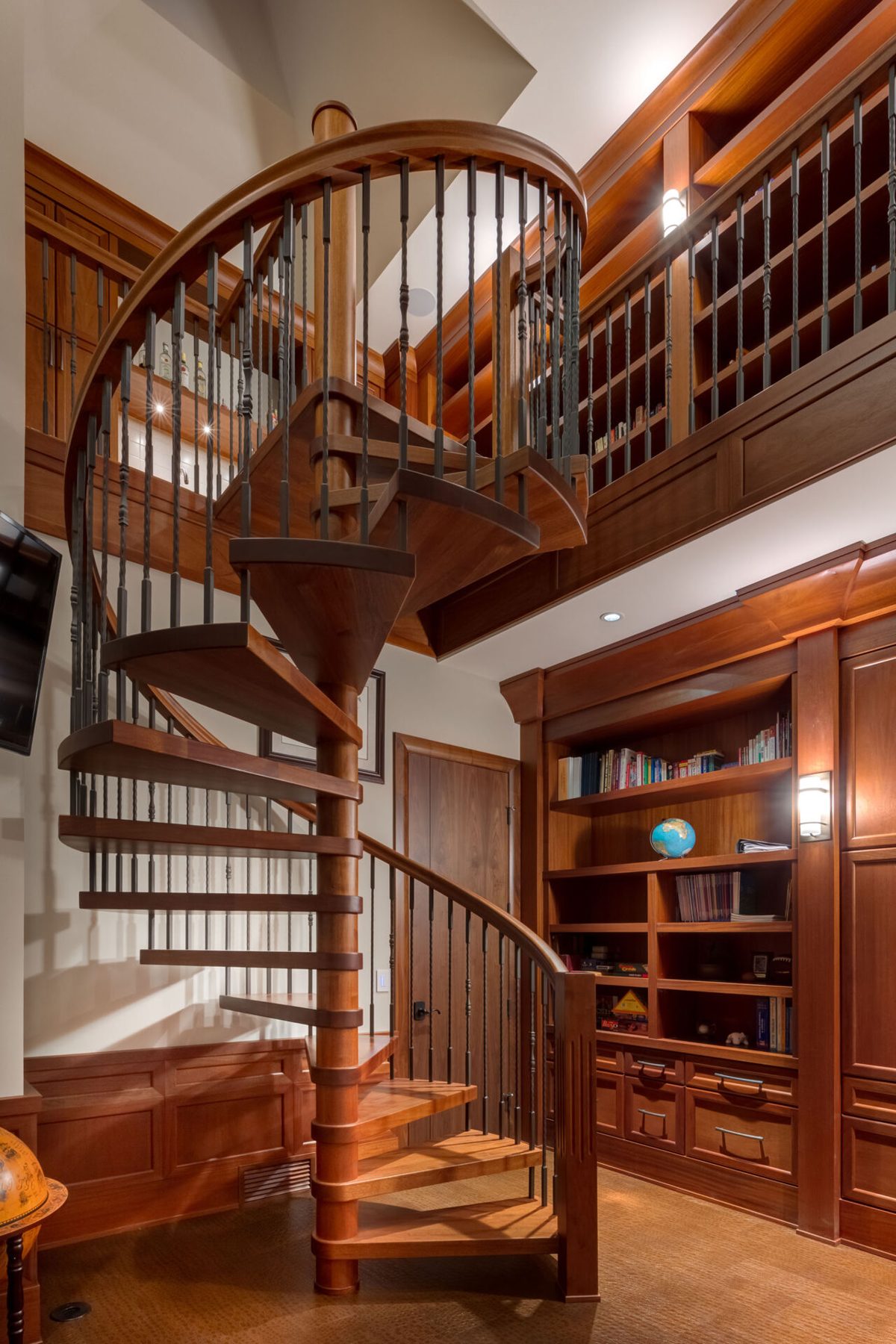 Wooden spiral staircase with iron spindles in a library room — Oxford