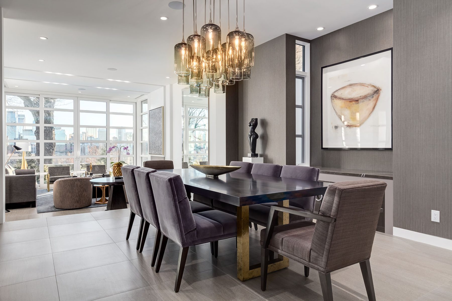 Modern dining room with plush velvet chairs, dark wood table, and large windows — Skyline