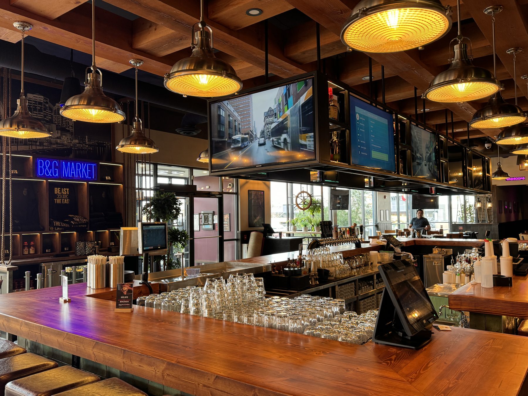 Modern bar interior with wooden counter, pendant lights, and multiple televisions — Blowers and Grafton (Shawnessy)
