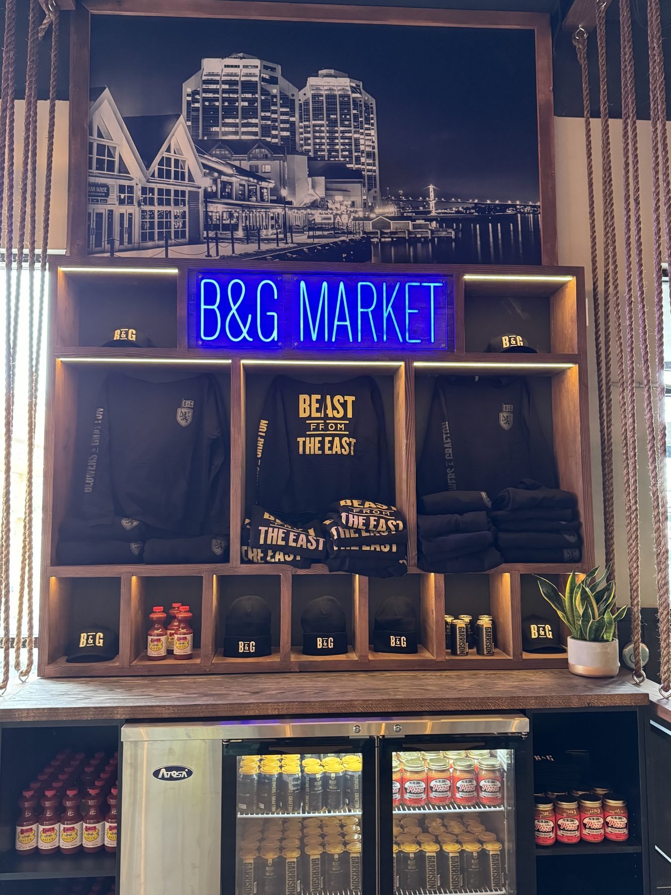 Market display featuring clothing, hats, sauces, and drinks — Blowers and Grafton (Shawnessy)