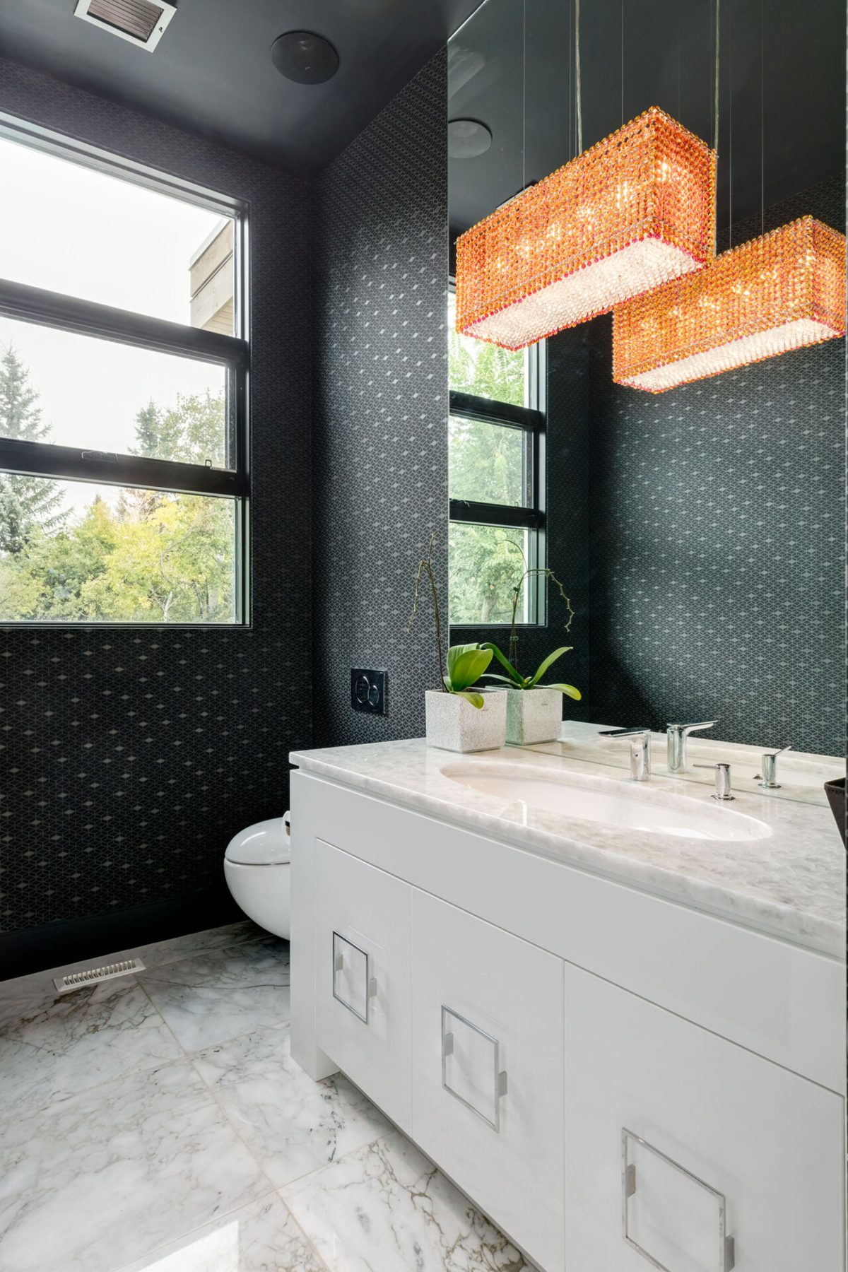 Modern bathroom with marble, patterned wallpaper, and crystal chandeliers — Germania