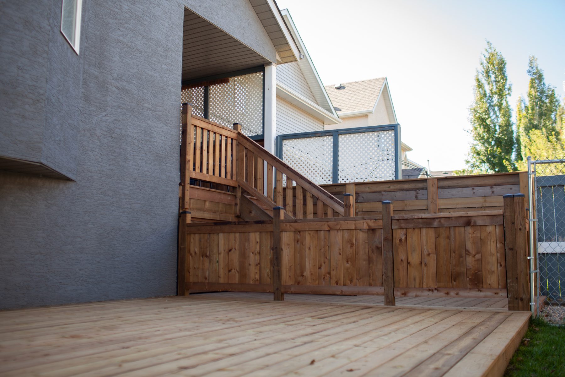 New wooden deck and stairs with lattice privacy screens — 32 Somercrest Manor SW