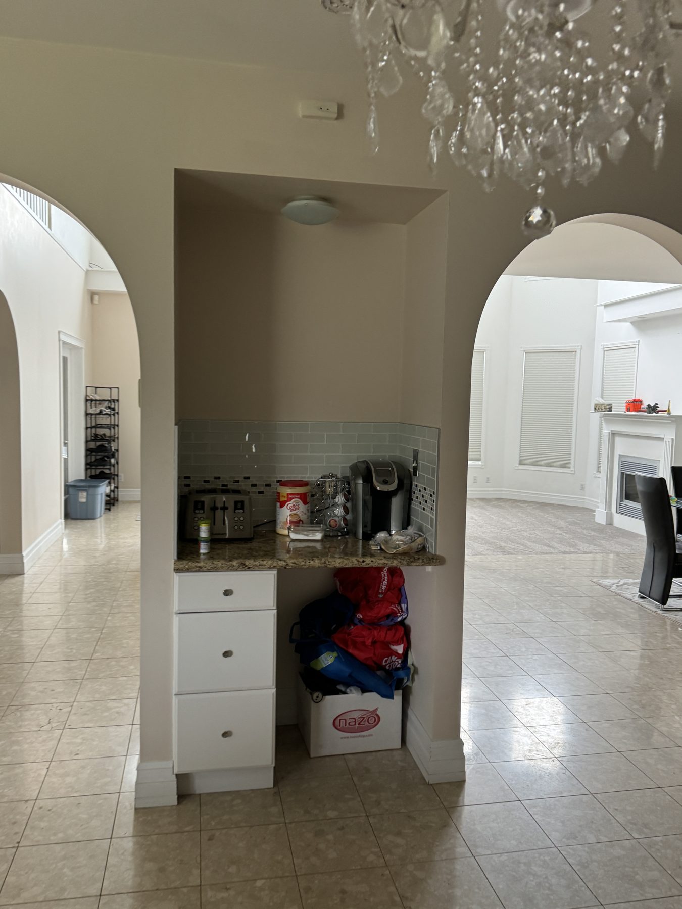Kitchenette under construction with coffee maker, toaster, and cabinets — 14 Lochend Drive, Cochrane
