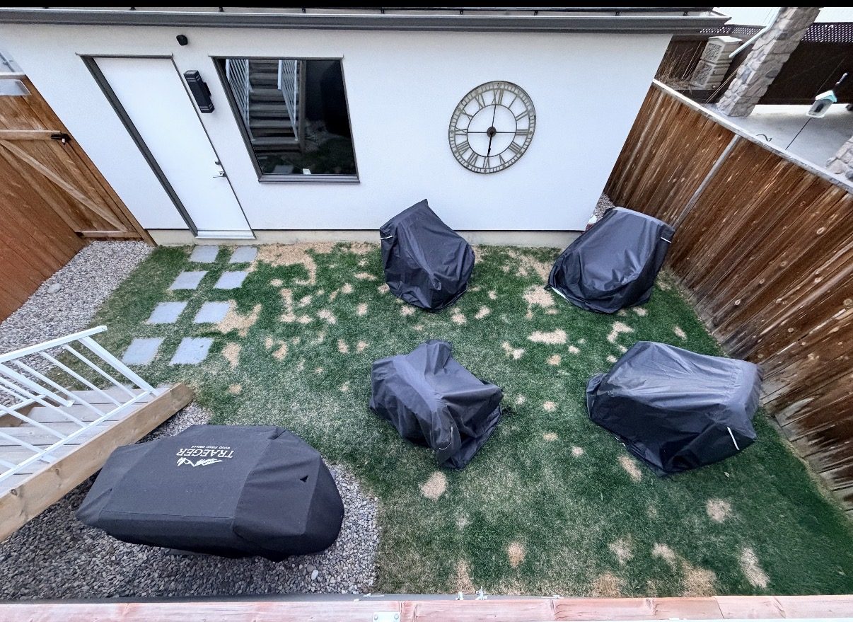 Backyard with covered grills, new grass, and a clock — 3505 41 Street SW, Calgary