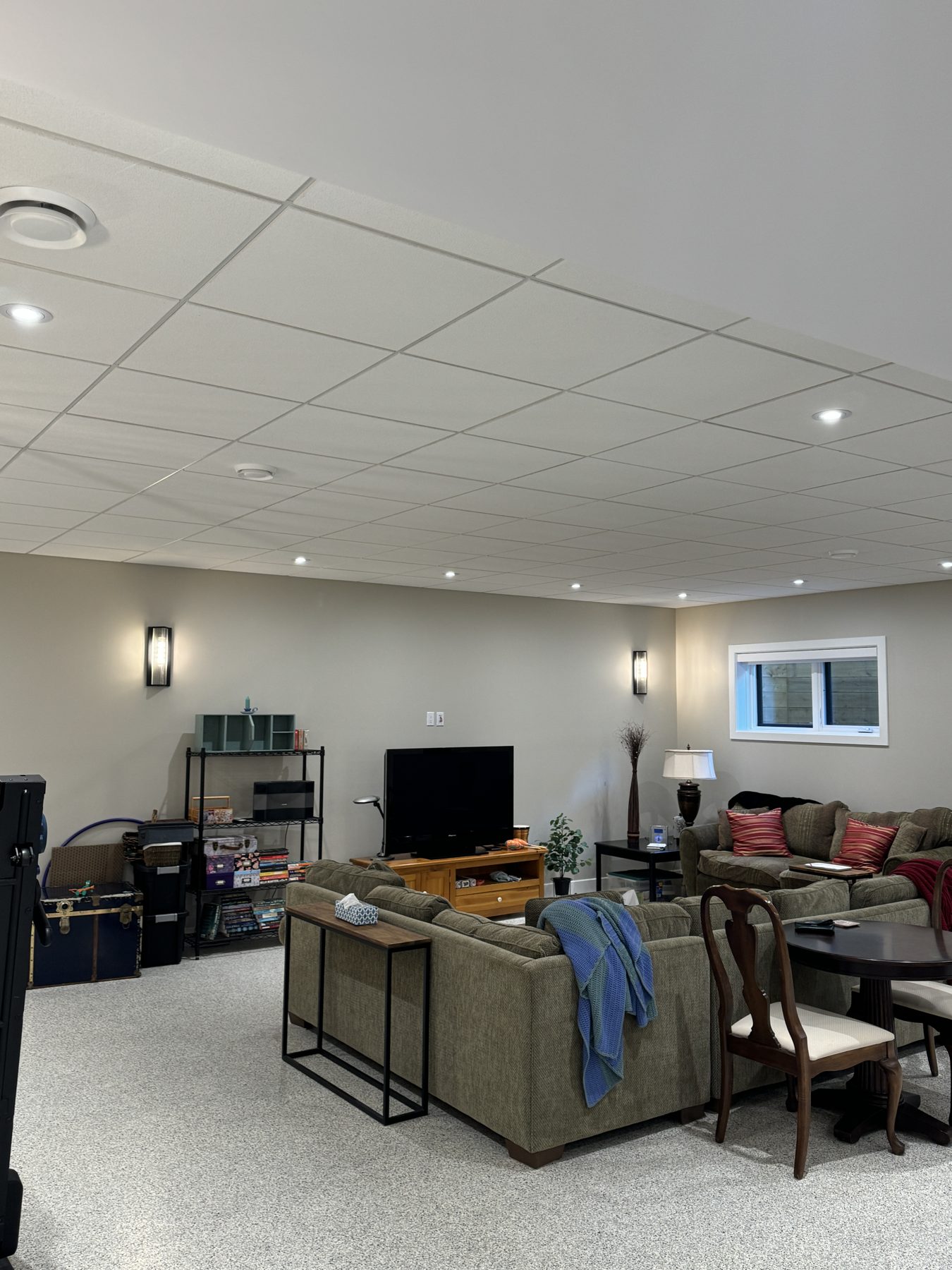 Finished basement living area with new suspended tile ceiling and lighting — 18 Varsplain Place Northwest