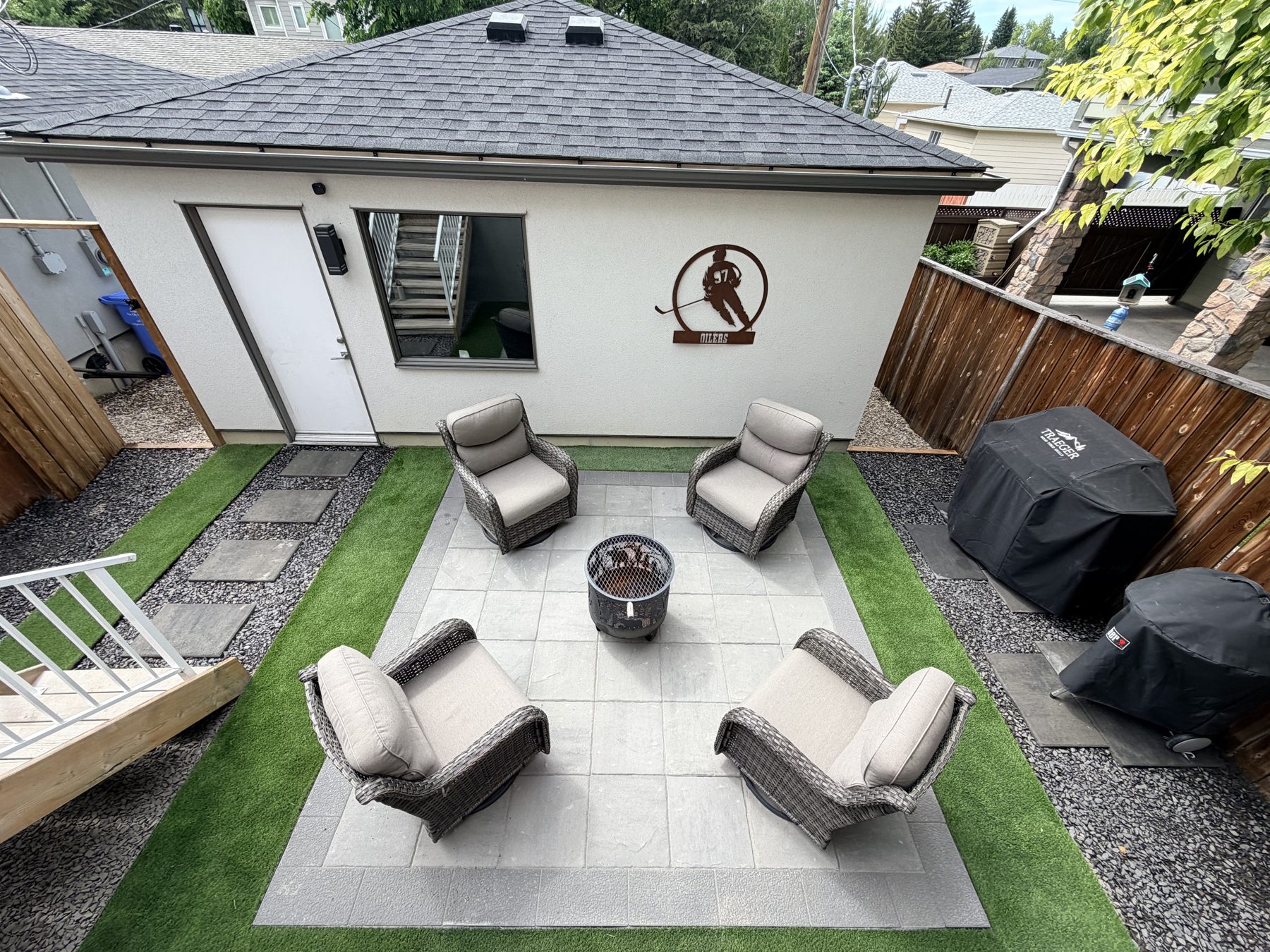 Backyard patio with artificial turf, seating, and grills — 3505 41 Street SW, Calgary