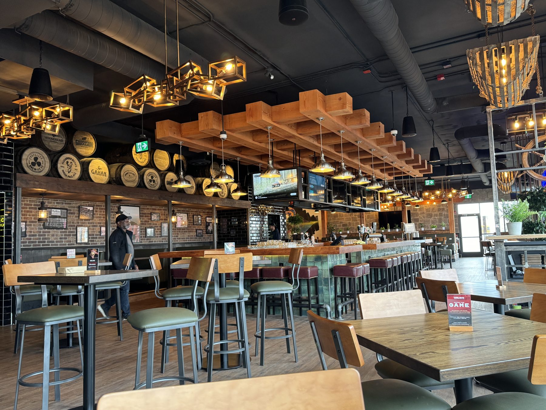Interior bar renovation with wooden beams, brick walls, and decorative lighting — Blowers and Grafton (Shawnessy)