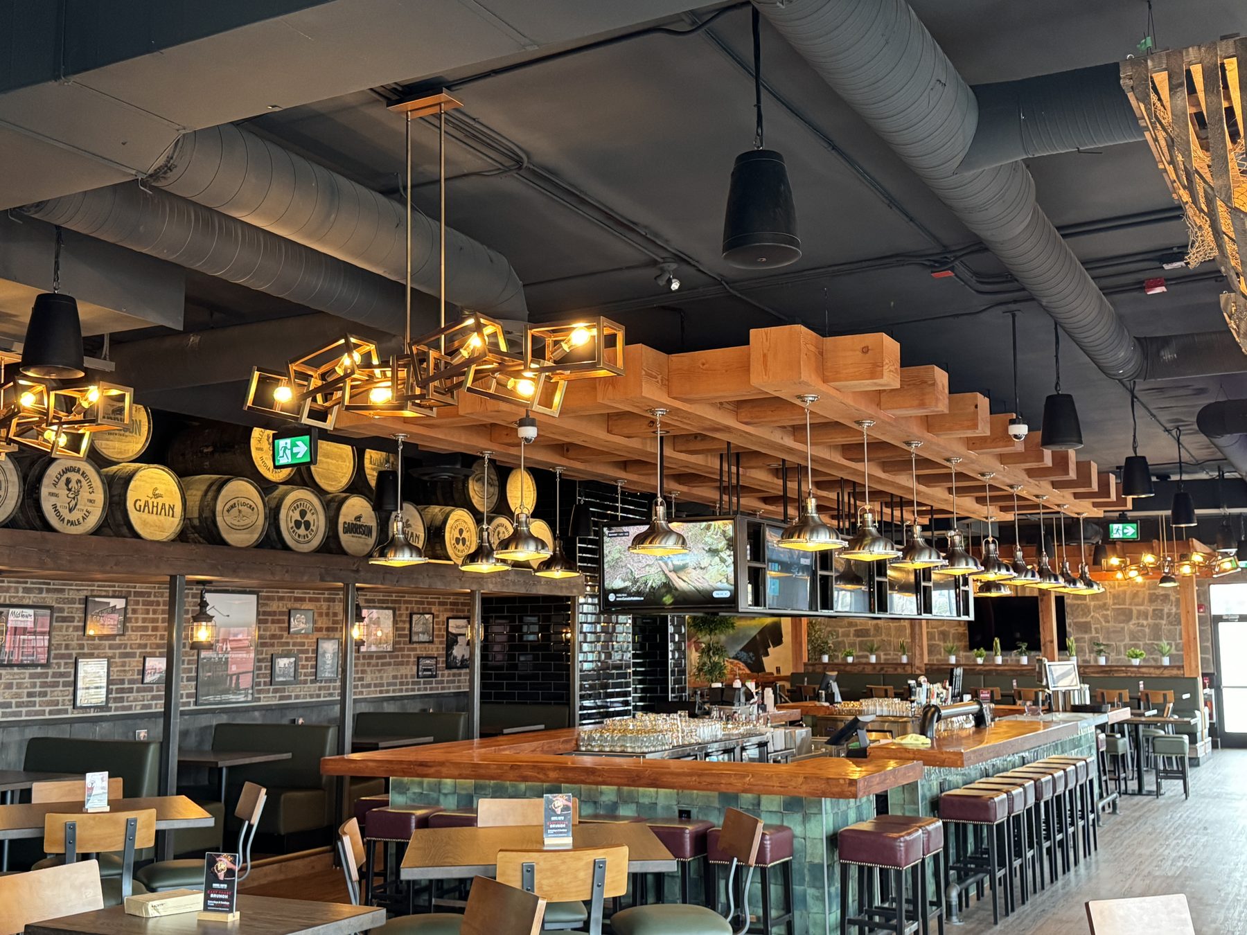 Restaurant bar with wooden beams, green tile, leather stools, and barrel decor — Blowers and Grafton (Shawnessy)