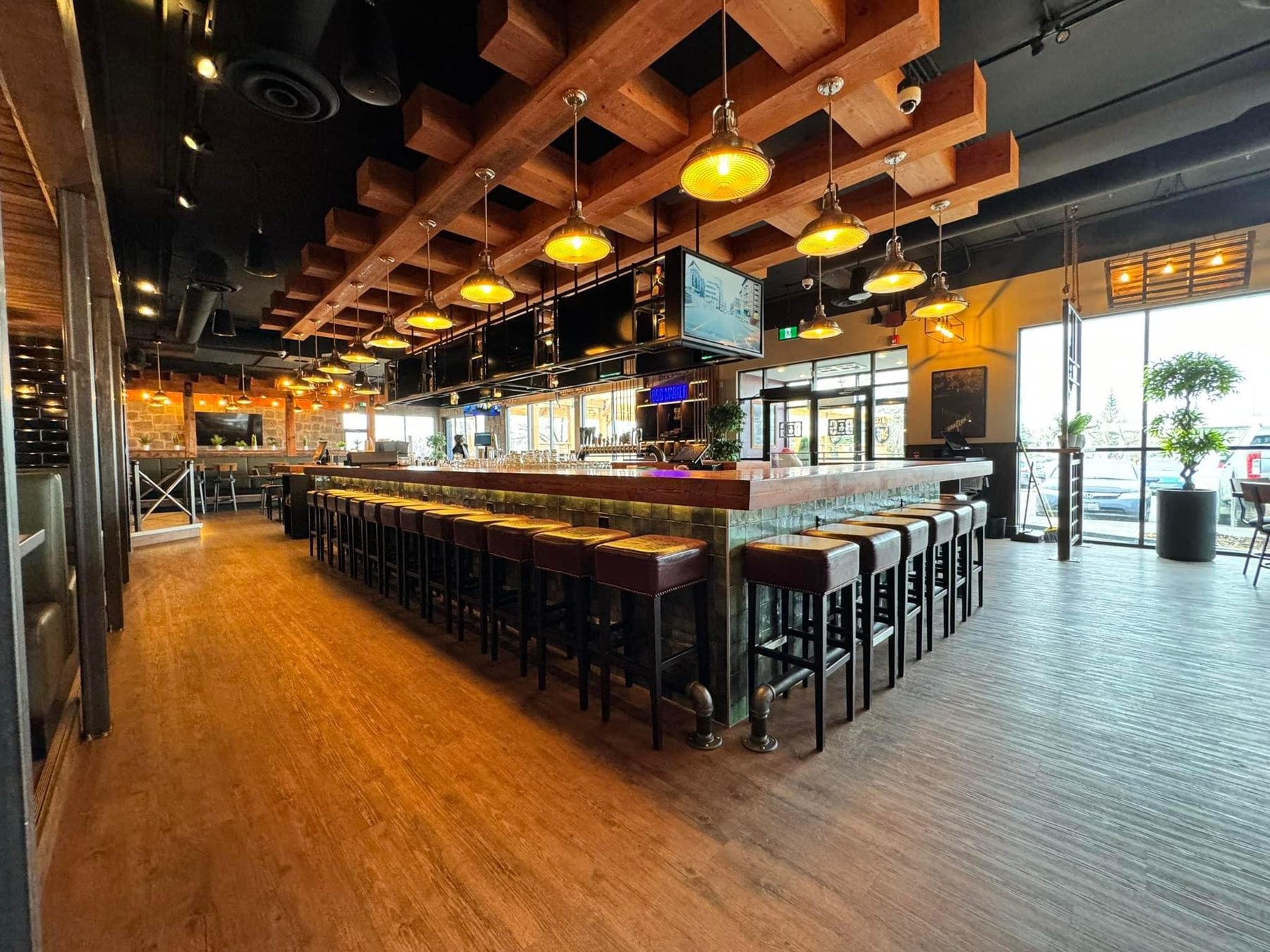 Modern bar with wood beams, pendant lights, and leather bar stools — Blowers and Grafton (Shawnessy)