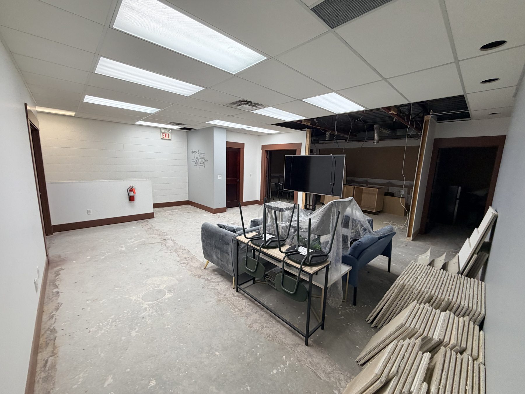Office space under renovation with unfinished ceiling and concrete floor — The Barron Venue