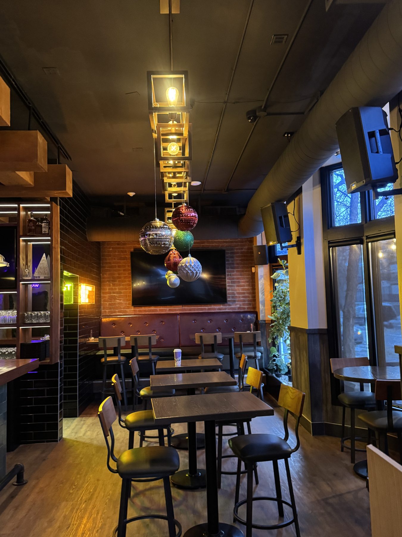 Restaurant dining area with brick walls, wood floor, and modern lighting fixtures — Blowers and Grafton (Mission)