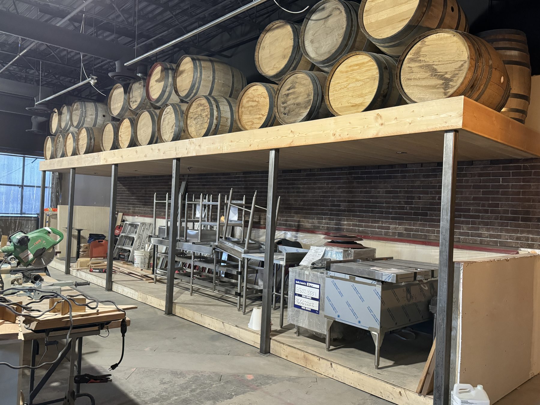 Construction site with barrels overhead and new stainless steel equipment — Blowers and Grafton (Medicine Hat)