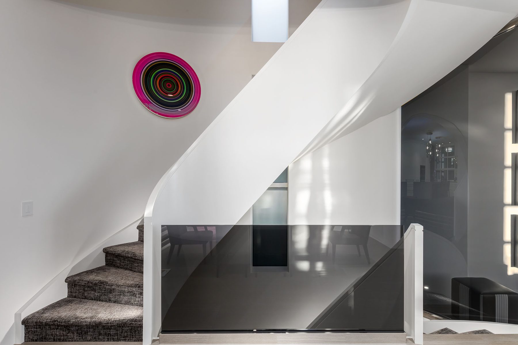 Modern staircase with glass railing and carpeted steps — Skyline