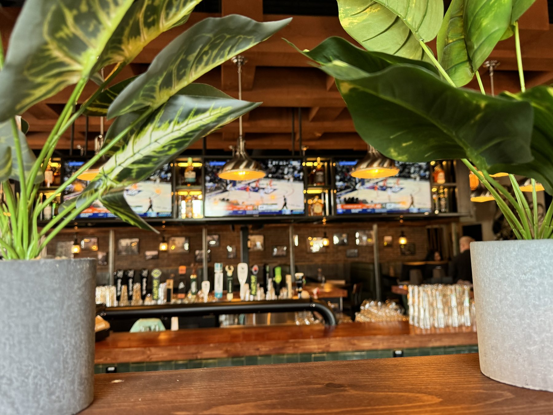 Bar with televisions, beer taps, and pendant lights, ready for patrons — Blowers and Grafton (Medicine Hat)