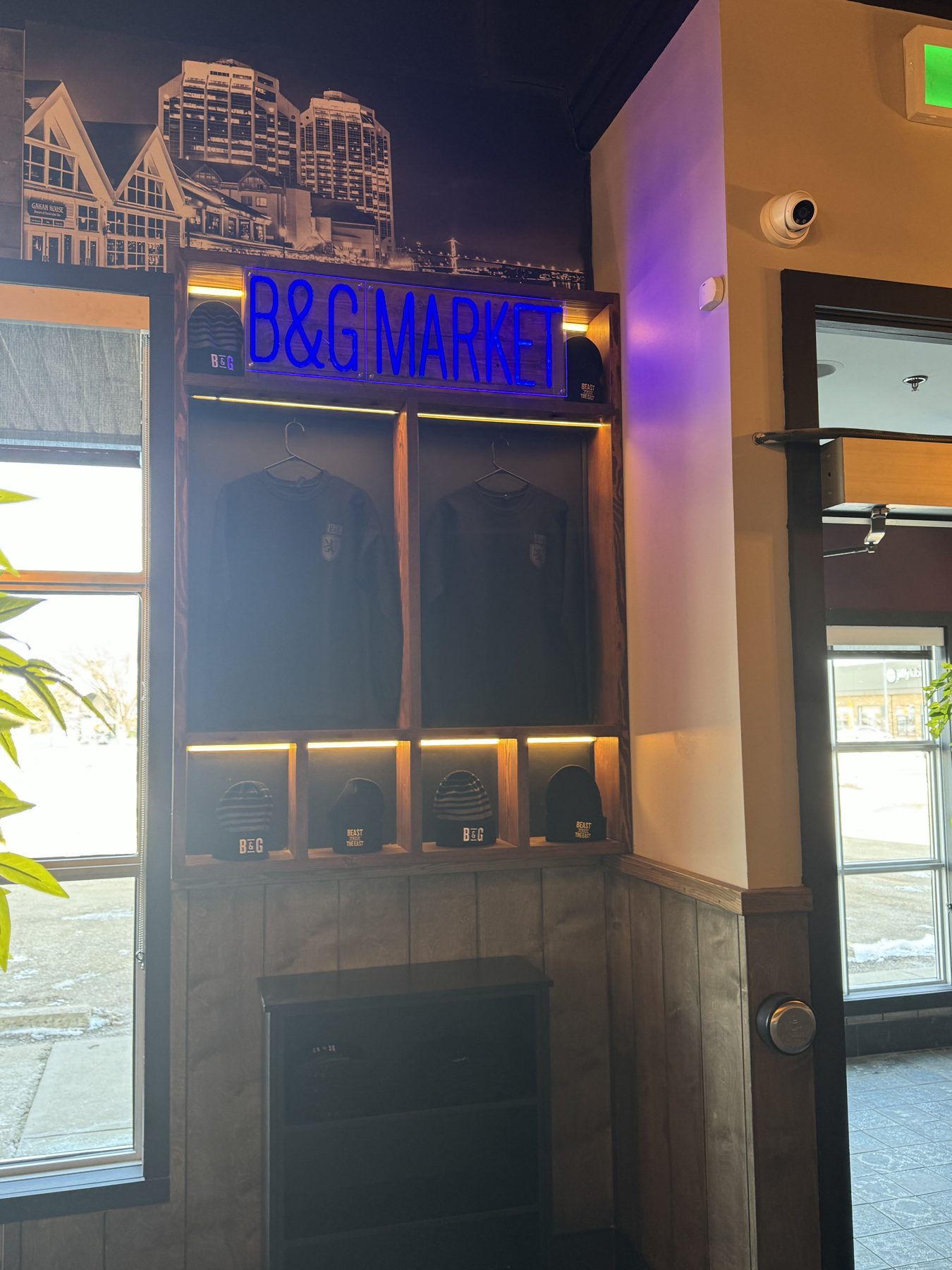 Display shelves holding clothing and hats with blue "B&G MARKET" sign — Blowers and Grafton (Medicine Hat)