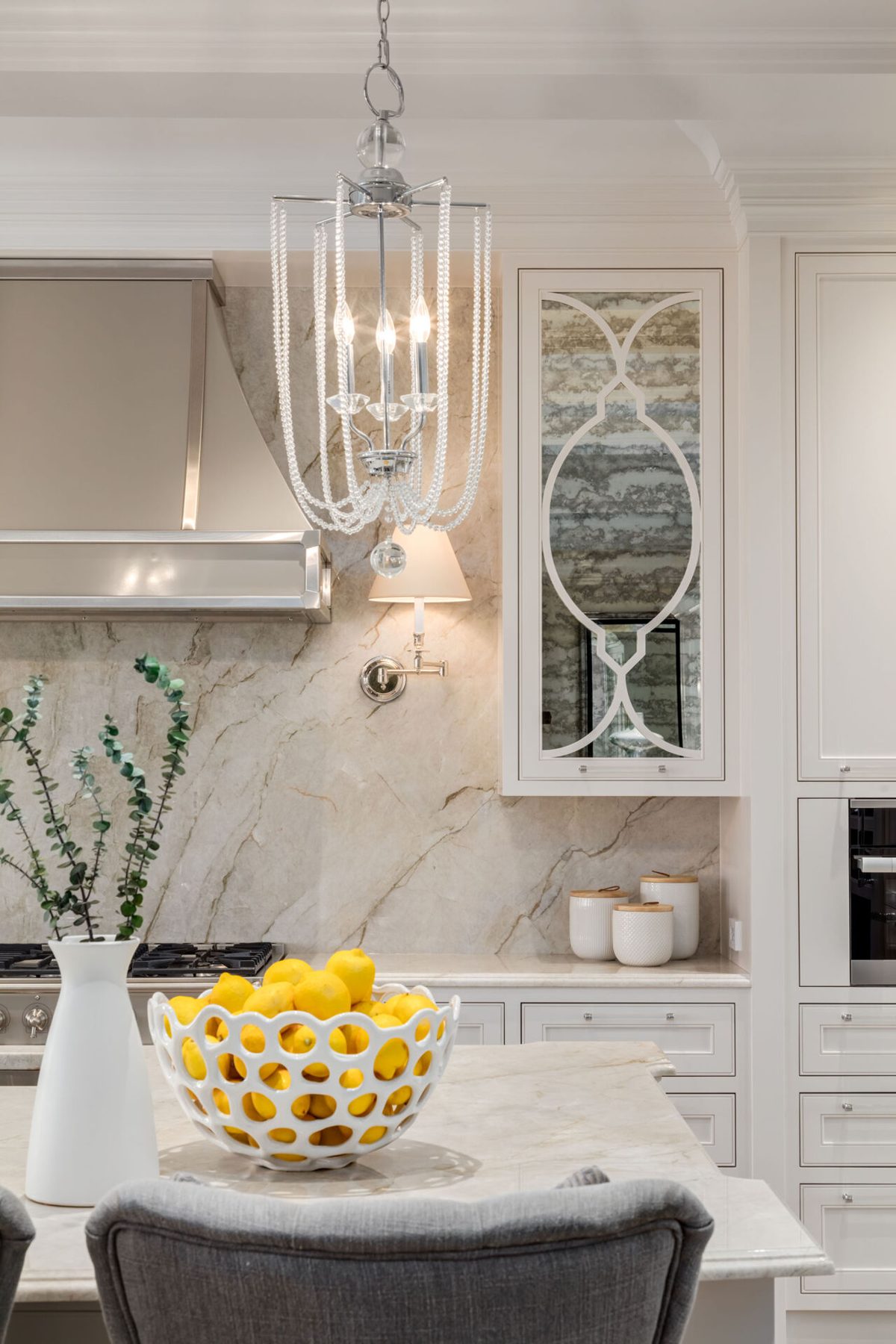Luxury kitchen island with marble, cabinetry, and crystal chandelier — White House