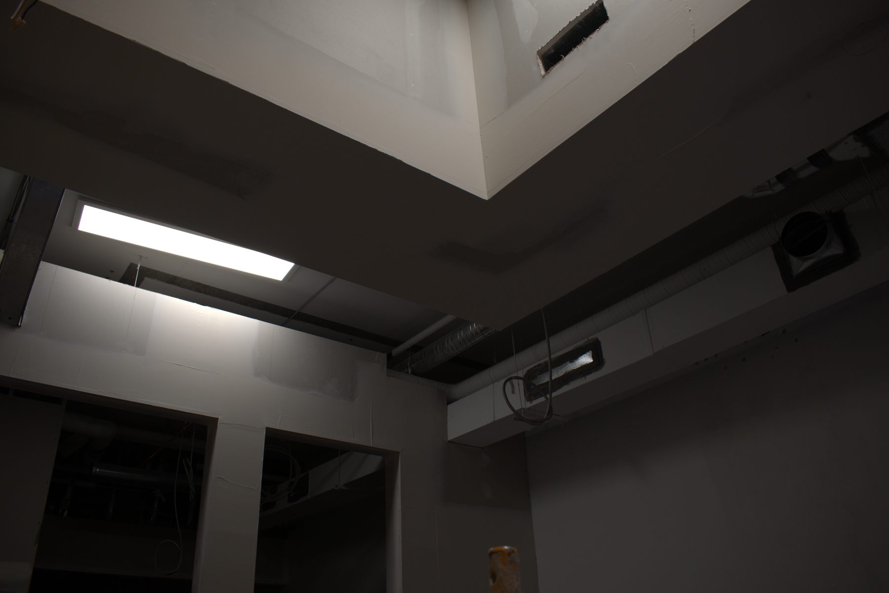 Unfinished room with drywall, light fixtures, and HVAC ductwork visible — Big Buns (Bowness)
