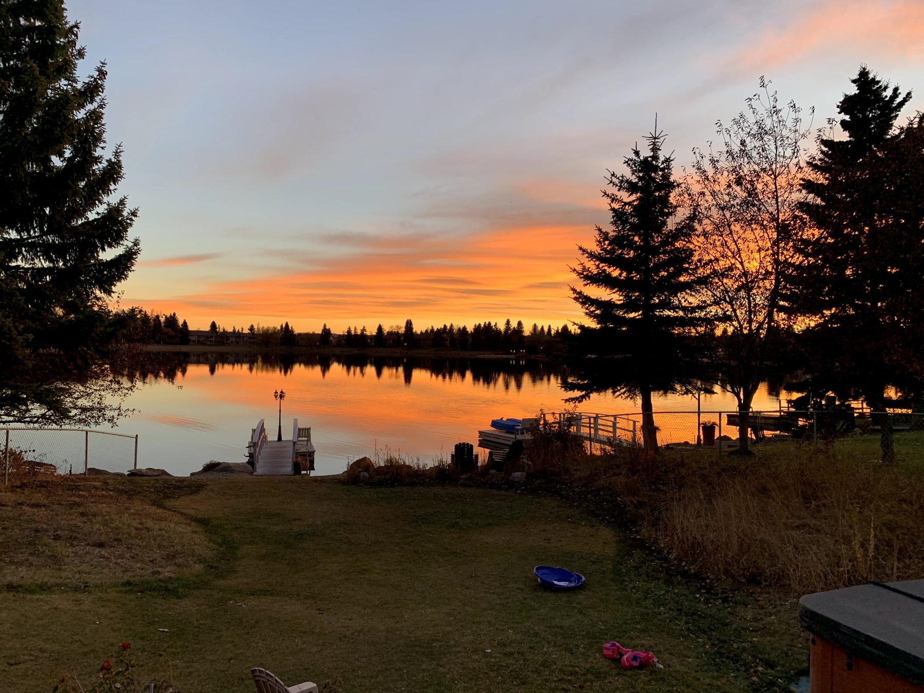 Dock construction with railings and lights at sunset — 7 Midlake Green SE, Calgary