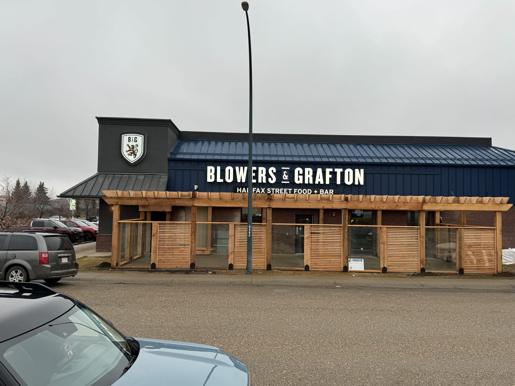 New wooden patio structure with glass panels, restaurant exterior — Blowers and Grafton (Medicine Hat)