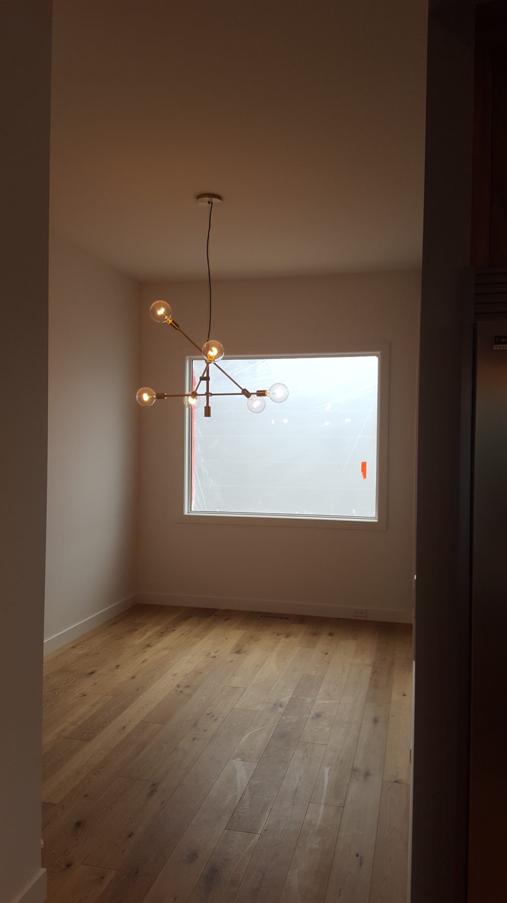 New hardwood floor, window protection, and modern chandelier installed — Briar Hill