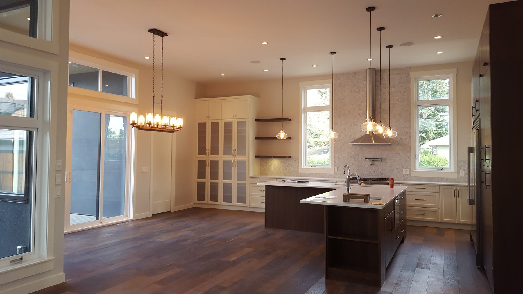 Modern kitchen renovation with island, subway tile, and dark wood floors — Briar Hill