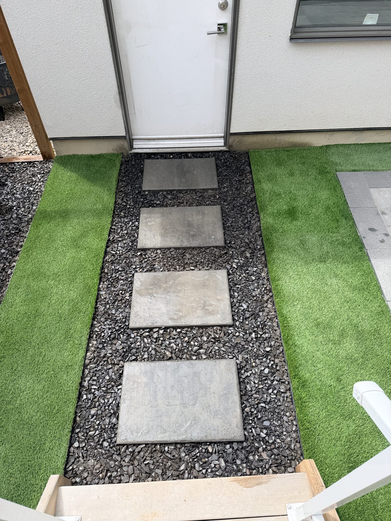 Backyard pathway with stepping stones, gravel, and artificial turf installed — 3505 41 Street SW, Calgary