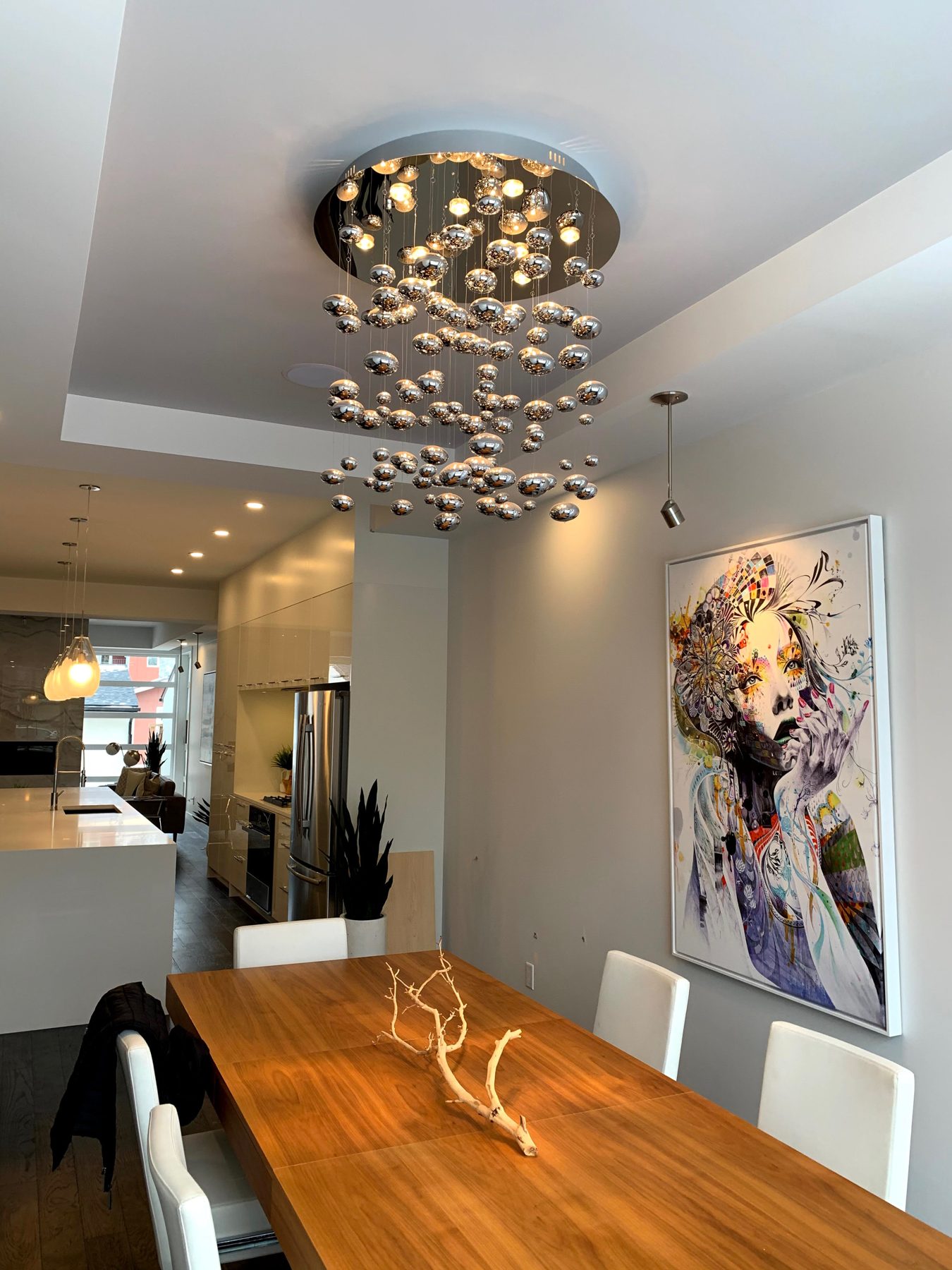 Modern dining room with large bubble chandelier and contemporary art — Clearmotive (Victoria Park) by Onsite Contracting Services