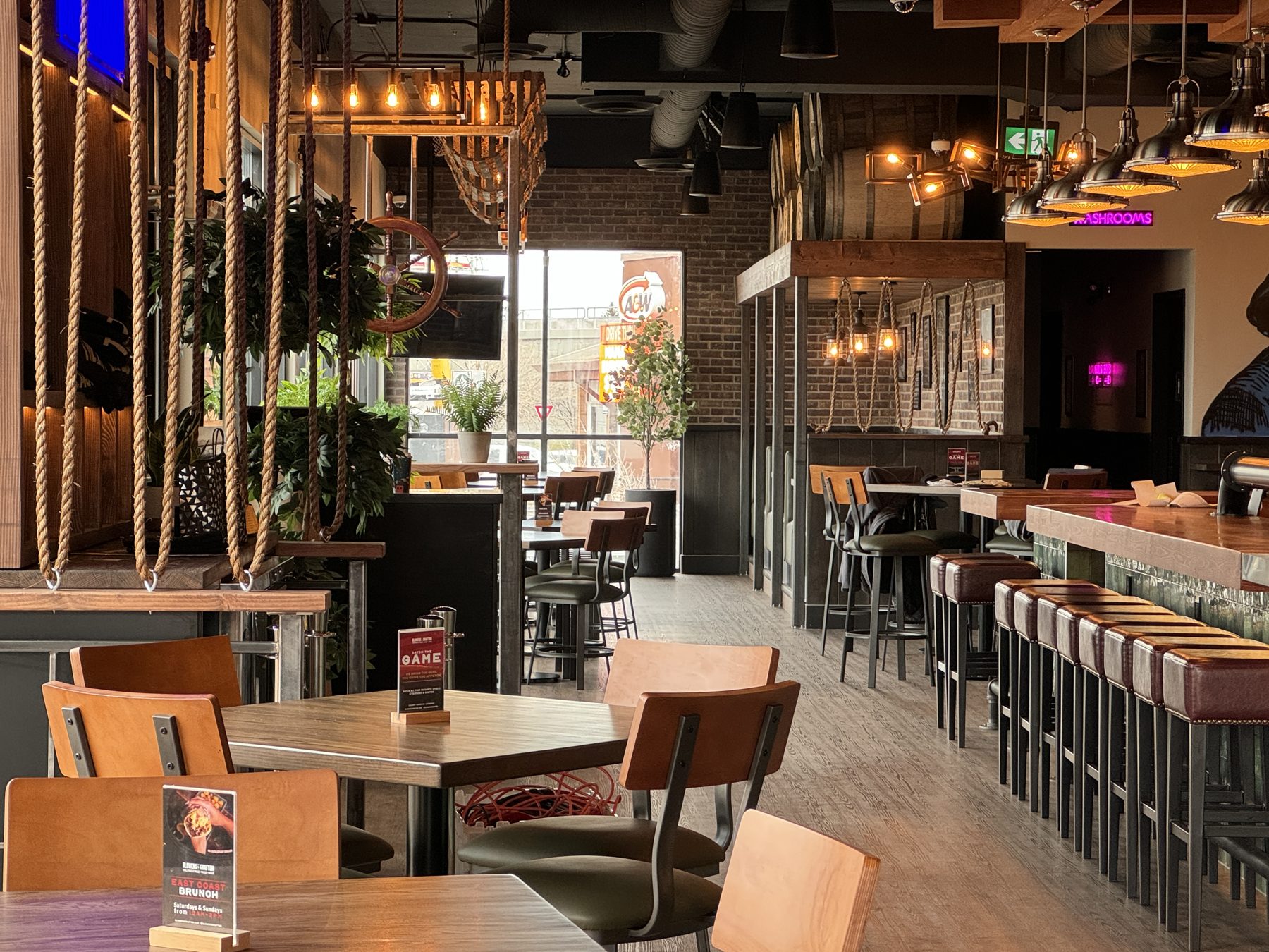Restaurant dining area with rope accents, wooden tables, and bar stools — Blowers and Grafton (Shawnessy)