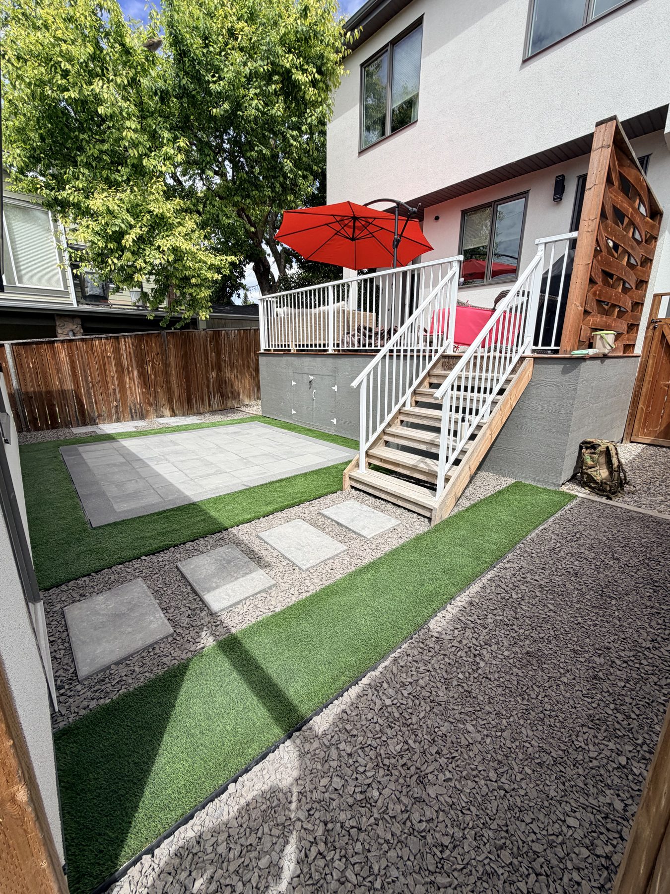 Backyard deck with stairs, pavers, and artificial turf landscaping — 3505 41 Street SW, Calgary
