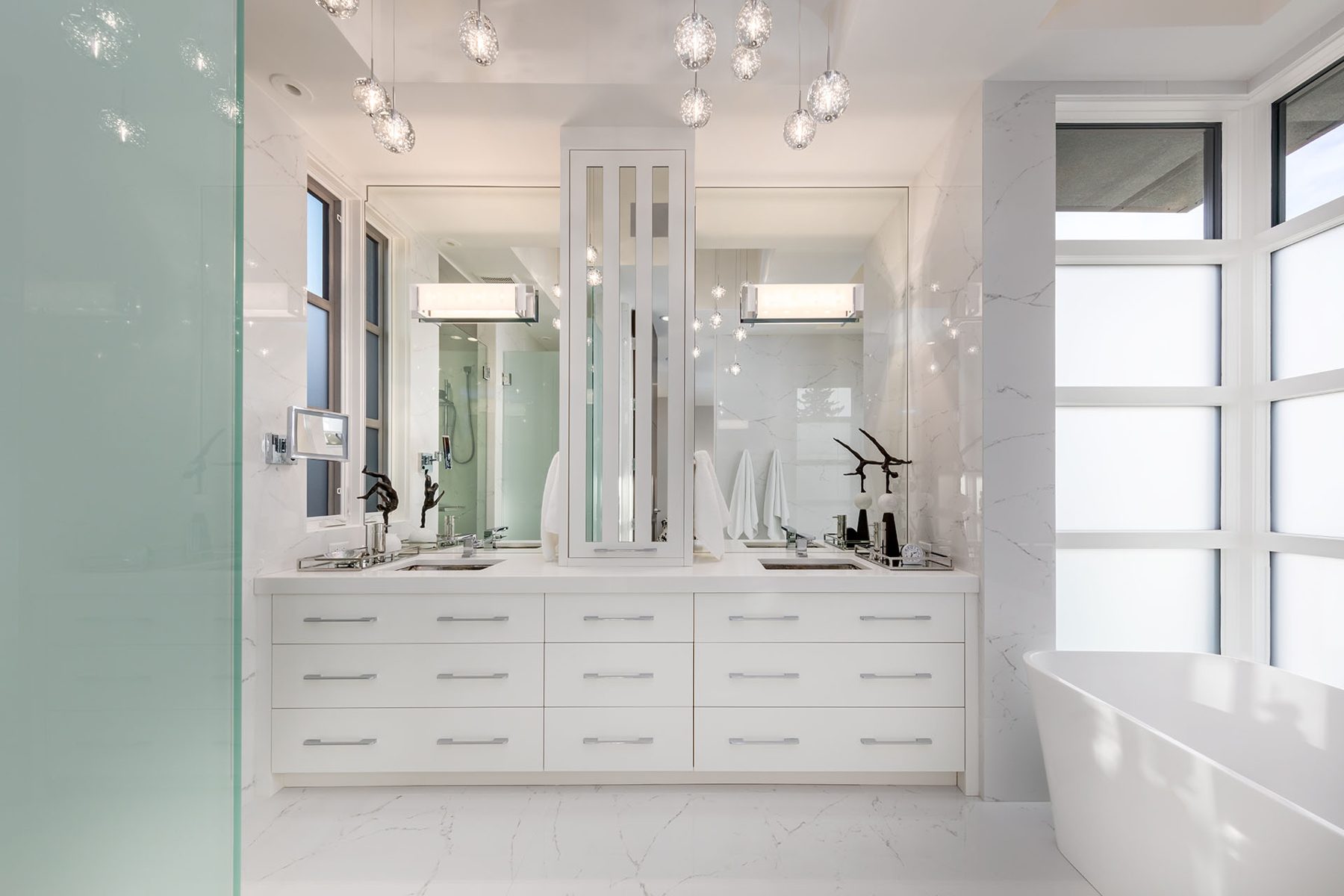 Modern bathroom vanity with dual sinks, marble tile, and dramatic lighting — Skyline