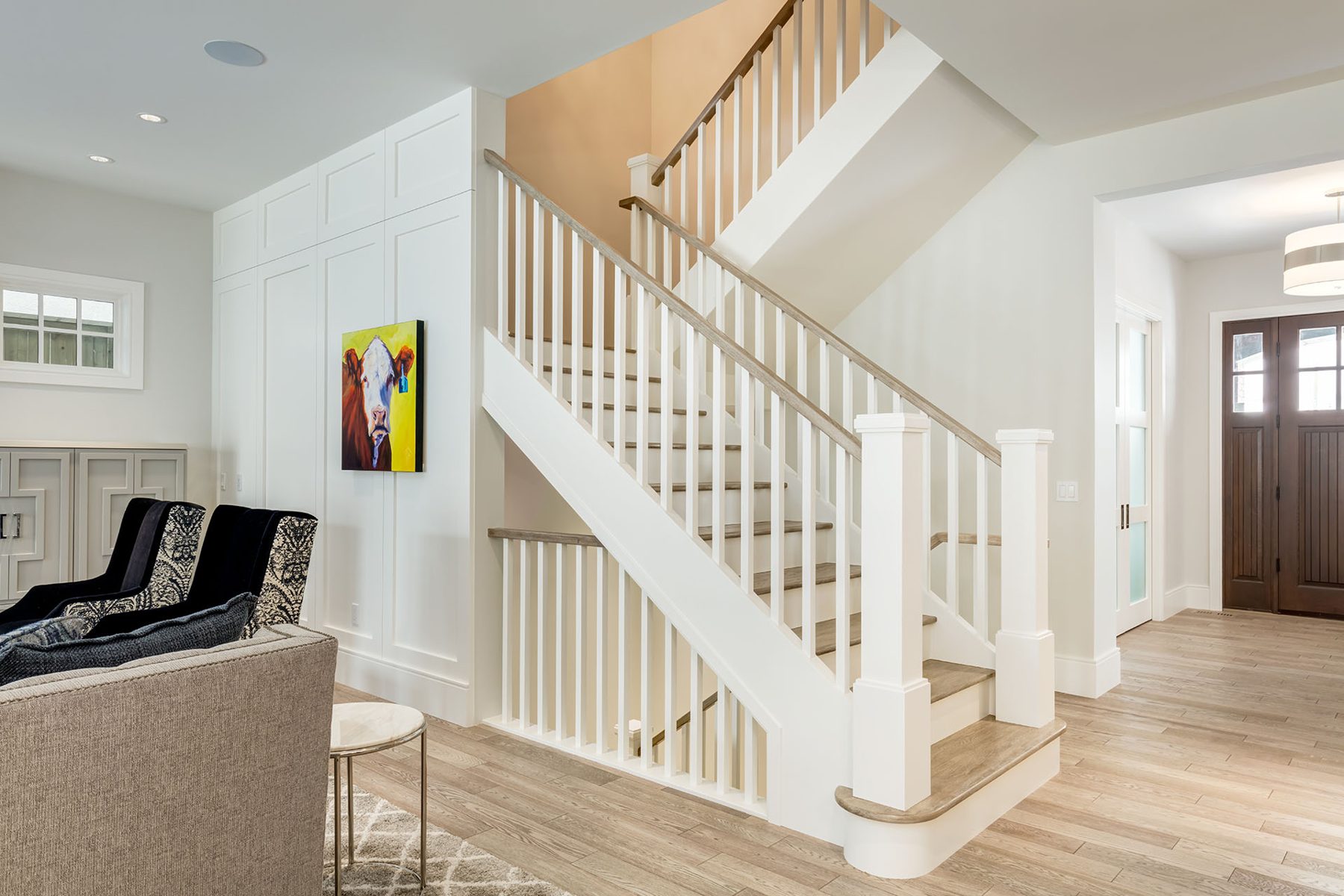 Modern staircase with white balusters and wood handrails, light wood floor — Cleret Velour