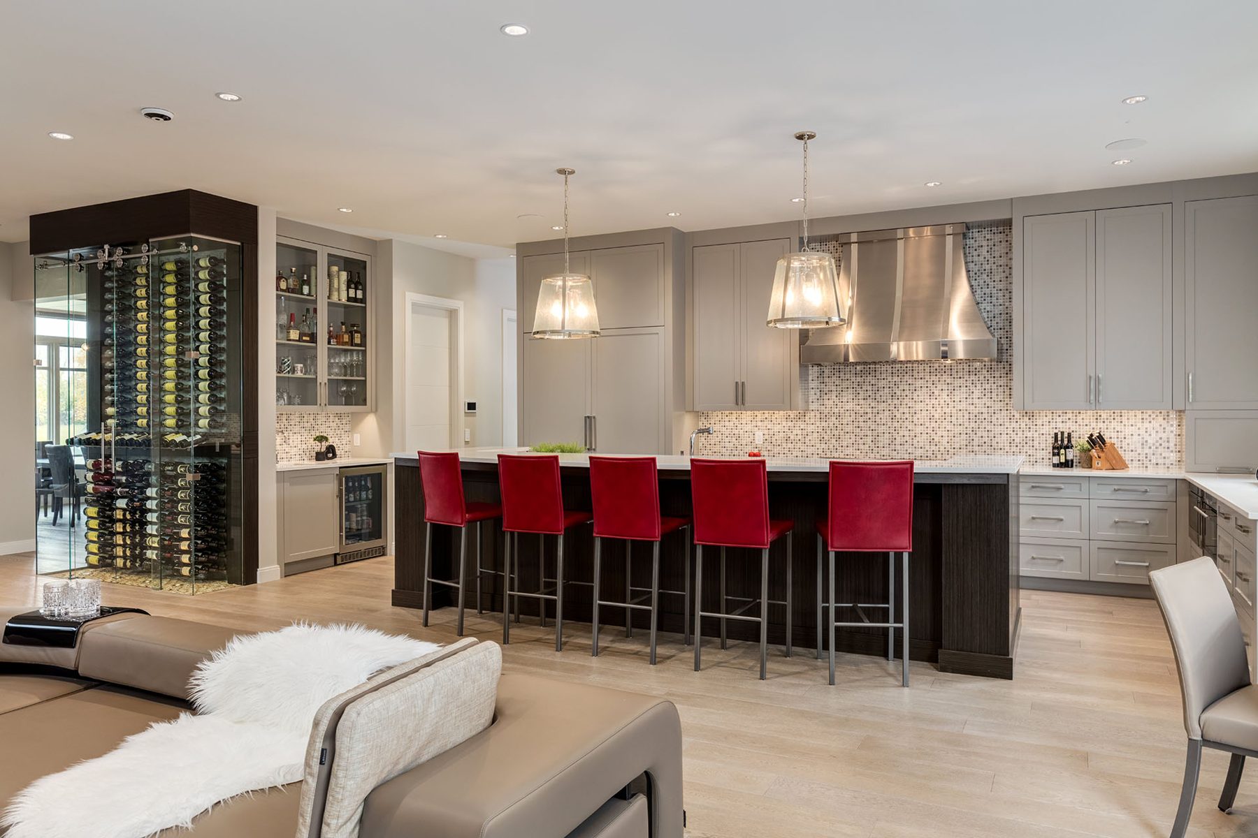 Modern kitchen with wine cellar, island, and seating — The Cellar