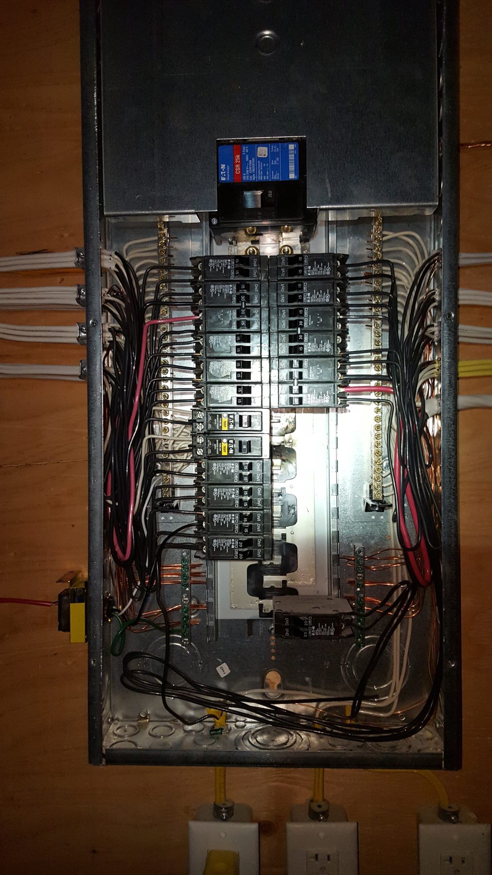 Electrical panel with breakers and wiring, under construction — Milan House, West Hillhurst, Calgary (Deanmark) by Onsite Contracting Services