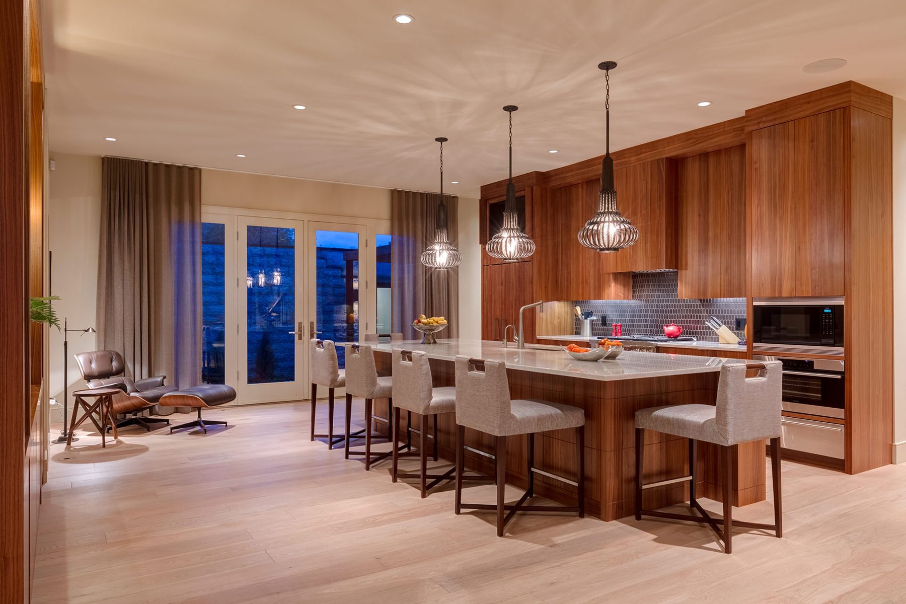 Modern kitchen island with pendant lights and seating, finished cabinets — Evolution